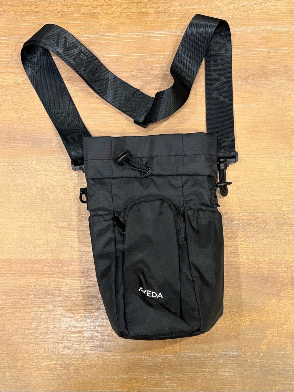 NEW AVEDA Black Crossbody water bottle bag with Branded Strap